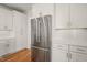Modern kitchen with stainless steel refrigerator and white cabinets at 7950 Country Knoll Rd, Bahama, NC 27503