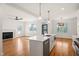 Kitchen island with quartz countertop, stainless steel appliances, and open to the living room at 7950 Country Knoll Rd, Bahama, NC 27503