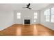 Spacious living room with hardwood floors, fireplace, and lots of natural light at 7950 Country Knoll Rd, Bahama, NC 27503