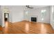 Bright living room with a fireplace, hardwood floors, and white trim at 7950 Country Knoll Rd, Bahama, NC 27503
