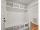Bright mudroom with built-in bench, storage cubbies, and stylish patterned tile flooring at 7950 Country Knoll Rd, Bahama, NC 27503