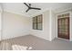 Back patio with ceiling fan, wood flooring, and an access door at 7950 Country Knoll Rd, Bahama, NC 27503
