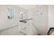Bright staircase landing featuring black handrails and large windows at 7950 Country Knoll Rd, Bahama, NC 27503