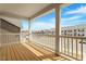 Covered balcony with wood floors, white railings, and neighborhood views at 813 James J Freeland Dr, Hillsborough, NC 27278