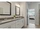 Sleek bathroom featuring dual sinks, gray countertops, and modern fixtures at 813 James J Freeland Dr, Hillsborough, NC 27278
