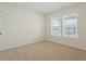 Minimalist bedroom with carpeted floor, two windows, and neutral paint at 813 James J Freeland Dr, Hillsborough, NC 27278