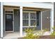 Inviting front entrance with white columns, dark trim, and meticulous landscaping creates a warm welcome at 813 James J Freeland Dr, Hillsborough, NC 27278