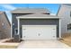 Exterior view of garage showcasing gray siding, white trim, and black decorative garage door hardware at 813 James J Freeland Dr, Hillsborough, NC 27278
