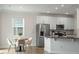 Bright, spacious kitchen with stainless steel appliances, a central island, and a cozy breakfast nook, inviting and functional at 813 James J Freeland Dr, Hillsborough, NC 27278