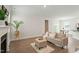 Bright living room features fireplace, neutral decor, and views into the dining area at 813 James J Freeland Dr, Hillsborough, NC 27278