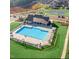Aerial view of a large community pool surrounded by lounge chairs and green space at 813 James J Freeland Dr, Hillsborough, NC 27278