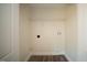 Small laundry room has connections for a washer and dryer, shelf, and flooring at 10 Golden Poppy Ln, Youngsville, NC 27596
