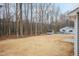 Spacious backyard featuring a shed and surrounding trees at 100 Gates St, Roxboro, NC 27573