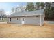 Exterior view of the back of the home with a patio and gray vinyl siding at 100 Gates St, Roxboro, NC 27573