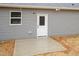 Home's exterior back featuring a concrete patio and neutral vinyl siding at 100 Gates St, Roxboro, NC 27573