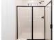 Modern bathroom features a frameless shower with black fixtures and a large window at 100 Gates St, Roxboro, NC 27573