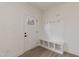 Bright entryway featuring white walls, a coat rack, and a built-in bench with storage at 100 Gates St, Roxboro, NC 27573
