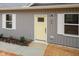 Charming home exterior showcasing a bright yellow door and gray siding at 100 Gates St, Roxboro, NC 27573