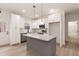 Bright kitchen featuring stainless steel appliances, white cabinets, and a gray island with granite countertops at 100 Gates St, Roxboro, NC 27573