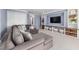 A spacious basement featuring built-in shelving and a large sectional sofa at 100 Lochberry Ln, Cary, NC 27518