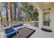 Inviting outdoor deck area with comfortable seating and views of the surrounding woods at 100 Lochberry Ln, Cary, NC 27518