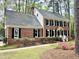 Charming two-story brick home with black shutters and a well-manicured front yard, offering classic curb appeal at 100 Lochberry Ln, Cary, NC 27518