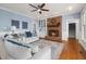 Comfortable living room featuring a brick fireplace, plush seating, and neutral decor, creating a cozy atmosphere at 100 Lochberry Ln, Cary, NC 27518