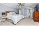 Spacious main bedroom with a ceiling fan and ensuite bathroom entrance at 100 Lochberry Ln, Cary, NC 27518