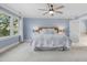 Sunlit main bedroom with a ceiling fan and a large window with sheer curtains at 100 Lochberry Ln, Cary, NC 27518