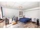 Comfortable bedroom features wood-look flooring, white paneled walls, and natural light at 105 Elizabeth St, Chapel Hill, NC 27514