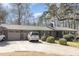Charming brick home featuring an attached garage, mature trees, and a well-manicured lawn at 105 Elizabeth St, Chapel Hill, NC 27514