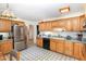 Traditional-style kitchen with wooden cabinets, stainless steel refrigerator, and ample counter space at 105 Elizabeth St, Chapel Hill, NC 27514