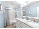 Bright bathroom featuring a double vanity, updated fixtures, and tiled shower and tub at 109 S Fern Abbey Ln, Cary, NC 27518