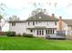 Back of two story house with bright green lawn and small deck at 109 S Fern Abbey Ln, Cary, NC 27518