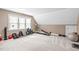 Spacious bonus room/gym with carpeted floors and a variety of exercise equipment at 109 S Fern Abbey Ln, Cary, NC 27518