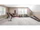 Finished bonus room/gym with carpeted floors and a variety of exercise equipment at 109 S Fern Abbey Ln, Cary, NC 27518