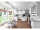 Bright, eat-in kitchen featuring white cabinetry, granite countertops and stainless steel appliances at 109 S Fern Abbey Ln, Cary, NC 27518