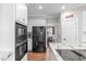 Modern kitchen featuring a stainless steel refrigerator, wall oven, and a walk-in pantry at 109 S Fern Abbey Ln, Cary, NC 27518