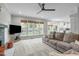 Comfortable living area with fireplace, large windows and view into kitchen at 109 S Fern Abbey Ln, Cary, NC 27518