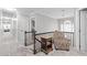 Upstairs landing with a patterned accent chair, dark railing, and light-colored walls at 109 S Fern Abbey Ln, Cary, NC 27518