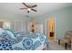 Bright bedroom features a ceiling fan and a doorway leading to the bathroom at 109 Shale Creek Dr, Durham, NC 27703