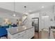 Open concept kitchen with granite counters, stainless steel appliances, with sightlines to living areas at 109 Shale Creek Dr, Durham, NC 27703