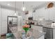 Modern kitchen with stainless steel appliances, granite countertops, and stylish lighting fixtures, and island with tulip display at 109 Shale Creek Dr, Durham, NC 27703