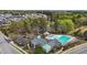 An aerial of the community pool, clubhouse, and parking with a lake in the background at 1094 Ambergate Sta, Apex, NC 27502