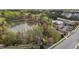 Aerial view of a serene lake with pool in the background and lush green trees at 1094 Ambergate Sta, Apex, NC 27502