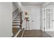 Entryway featuring wood floors, staircase with dark wood trim, and white accents at 1094 Ambergate Sta, Apex, NC 27502