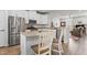 Modern kitchen with stainless appliances, granite countertops, and a functional island at 1094 Ambergate Sta, Apex, NC 27502