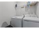 Laundry room with modern washing machine and dryer, featuring shelving for storage at 1094 Ambergate Sta, Apex, NC 27502