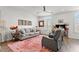 Bright living room with gray sofa, accent rug, and ample natural light at 1094 Ambergate Sta, Apex, NC 27502