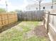 Fenced backyard featuring a mix of grass and mulch with partial sun exposure at 1220 Garner Rd, Raleigh, NC 27610